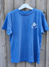 Load image into Gallery viewer, Blue shirt with a logo on a wooden surface
